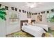 Bright bedroom with twin beds, pirate-themed decorations, and large windows providing natural light at 4324 S Clark Ave, Tampa, FL 33611