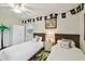 Charming bedroom with two twin beds, pirate decor, white walls, and a ceiling fan for comfortable living at 4324 S Clark Ave, Tampa, FL 33611