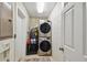 Functional laundry room with modern stacked washer and dryer units at 4324 S Clark Ave, Tampa, FL 33611