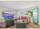 Inviting living room featuring a comfortable seating arrangement, a TV, and natural light from the window at 4324 S Clark Ave, Tampa, FL 33611