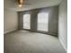 This bedroom has carpet flooring and 2 windows at 4617 Ashburn Square Dr, Tampa, FL 33610
