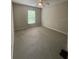 Cozy bedroom with neutral carpet, ceiling fan, and large window with natural light at 4617 Ashburn Square Dr, Tampa, FL 33610