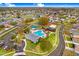 A vibrant aerial view of a community pool, playground, and recreational areas amid well-maintained streets at 4921 Wessex Way, Land O Lakes, FL 34639