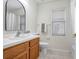 Bright bathroom featuring vanity with wood cabinets, and a window above the toilet at 4921 Wessex Way, Land O Lakes, FL 34639