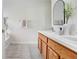 Bright bathroom featuring double vanity with wood cabinets and white countertop at 4921 Wessex Way, Land O Lakes, FL 34639