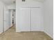Bright bedroom with neutral carpet and bi-fold closet doors at 4921 Wessex Way, Land O Lakes, FL 34639