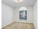 Neutral bedroom with a large window and plush carpet at 4921 Wessex Way, Land O Lakes, FL 34639
