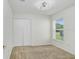 Bright bedroom featuring neutral carpet, bi-fold closet, and large window at 4921 Wessex Way, Land O Lakes, FL 34639