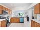 This kitchen features stainless appliances, white quartz counters and a bright blue dishwasher at 4921 Wessex Way, Land O Lakes, FL 34639