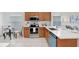 Bright kitchen features quartz countertops, stainless appliances and breakfast bar at 4921 Wessex Way, Land O Lakes, FL 34639