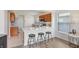 Open concept kitchen features a bar with seating that flows into the living area at 4921 Wessex Way, Land O Lakes, FL 34639