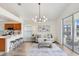 Living room with modern chandelier, stylish rug, and sliding glass doors at 4921 Wessex Way, Land O Lakes, FL 34639