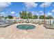 Community pool and lounge area with chairs and white picket fence is perfect for relaxation at 4921 Wessex Way, Land O Lakes, FL 34639