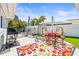 Outdoor patio featuring a grill, seating area and artificial grass at 501 Janice Pl, Indian Rocks Beach, FL 33785
