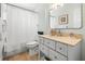 Cozy bathroom with a shower/tub combination, a vanity with storage, and neutral decor at 501 Janice Pl, Indian Rocks Beach, FL 33785