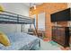 Bunk bedroom features rustic wood wall, dresser, and TV at 501 Janice Pl, Indian Rocks Beach, FL 33785