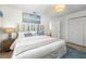 Bedroom with a beachy theme, featuring a custom headboard and serene wall art at 501 Janice Pl, Indian Rocks Beach, FL 33785