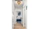 Hallway with a view into a bedroom featuring a patterned rug, creating a bright and inviting space at 501 Janice Pl, Indian Rocks Beach, FL 33785