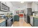 Spacious kitchen with stainless steel appliances, granite countertops, and a view into the dining area at 501 Janice Pl, Indian Rocks Beach, FL 33785