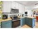 Modern kitchen with stainless steel appliances, granite countertops, and two-tone cabinetry at 501 Janice Pl, Indian Rocks Beach, FL 33785
