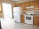 Functional kitchen with essential appliances, light wood cabinetry, and adjacent laundry area at 5110 Sunridge Palms Dr, Tampa, FL 33617