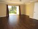 Bright living room with wood floors, ample natural light and sliding glass doors to private patio at 5110 Sunridge Palms Dr, Tampa, FL 33617