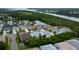 Aerial view of a residential neighborhood near a pond, featuring mature trees and well-maintained homes at 550 Salmon Ct, Oldsmar, FL 34677