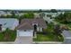 Aerial view of a well-maintained home featuring a two-car garage and manicured landscaping at 550 Salmon Ct, Oldsmar, FL 34677