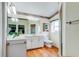 Bright bathroom with a white vanity, decorative accents, and wood-look flooring at 550 Salmon Ct, Oldsmar, FL 34677