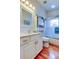 Bathroom features a vanity, wood-look floors, and a glass-enclosed shower and tub at 550 Salmon Ct, Oldsmar, FL 34677
