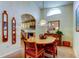 Dining area showcasing an archway to the kitchen with wooden chairs and decorative mirrors at 550 Salmon Ct, Oldsmar, FL 34677