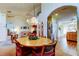 Cozy dining area with a round table, chandelier, and easy access to the kitchen and living room at 550 Salmon Ct, Oldsmar, FL 34677
