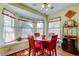 Bright dining room featuring a bay window and bar area, perfect for entertaining guests at 550 Salmon Ct, Oldsmar, FL 34677