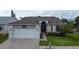 Charming single-story home with a brick driveway, two-car garage, and well-maintained landscaping at 550 Salmon Ct, Oldsmar, FL 34677