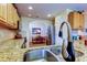 Well-lit kitchen with stainless steel appliances, tiled backsplash, and granite countertops at 550 Salmon Ct, Oldsmar, FL 34677
