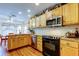 Bright kitchen with wooden cabinets, stainless steel appliances, and granite countertops, perfect for cooking at 550 Salmon Ct, Oldsmar, FL 34677