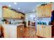 Spacious kitchen featuring light wooden cabinets, a stainless steel microwave, and granite countertops at 550 Salmon Ct, Oldsmar, FL 34677