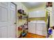 Efficient laundry room with a washer, dryer, storage shelves, and durable floors at 550 Salmon Ct, Oldsmar, FL 34677
