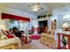 Comfortable living room featuring plush seating, a ceiling fan, and a seamless transition to the dining area at 550 Salmon Ct, Oldsmar, FL 34677