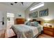 Comfortable main bedroom with a vaulted ceiling, art, and warm lamps at 550 Salmon Ct, Oldsmar, FL 34677