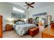 Spacious main bedroom featuring a vaulted ceiling, a ceiling fan, and sliding glass doors at 550 Salmon Ct, Oldsmar, FL 34677