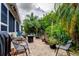 Cozy brick patio featuring a fire pit, comfortable seating, and lush landscaping at 550 Salmon Ct, Oldsmar, FL 34677