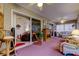 Bright sunroom with a cozy seating area, fireplace, and sliding glass door at 550 Salmon Ct, Oldsmar, FL 34677