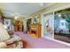 Bright sunroom with fireplace, ceiling fan, and sliding glass doors to the main bedroom at 550 Salmon Ct, Oldsmar, FL 34677