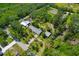 Aerial view showcasing a home with a large lot surrounded by lush greenery and nearby homes at 6104 Palm Ave, Gibsonton, FL 33534