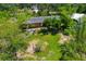 Aerial shot of a charming home with a well-maintained lawn and established trees for shade at 6104 Palm Ave, Gibsonton, FL 33534
