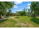 Spacious backyard with mature trees and greenery, creating a private and peaceful outdoor oasis at 6104 Palm Ave, Gibsonton, FL 33534