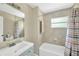 Standard bathroom featuring tile floor, shower-tub combination, single sink vanity, and tiled walls at 6104 Palm Ave, Gibsonton, FL 33534