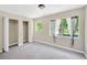 Bedroom with carpet, closet, and two windows at 6104 Palm Ave, Gibsonton, FL 33534