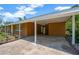 Carport features brick and concrete accents, adjacent to the home's entrance at 6104 Palm Ave, Gibsonton, FL 33534